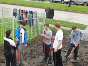 Young people digging.