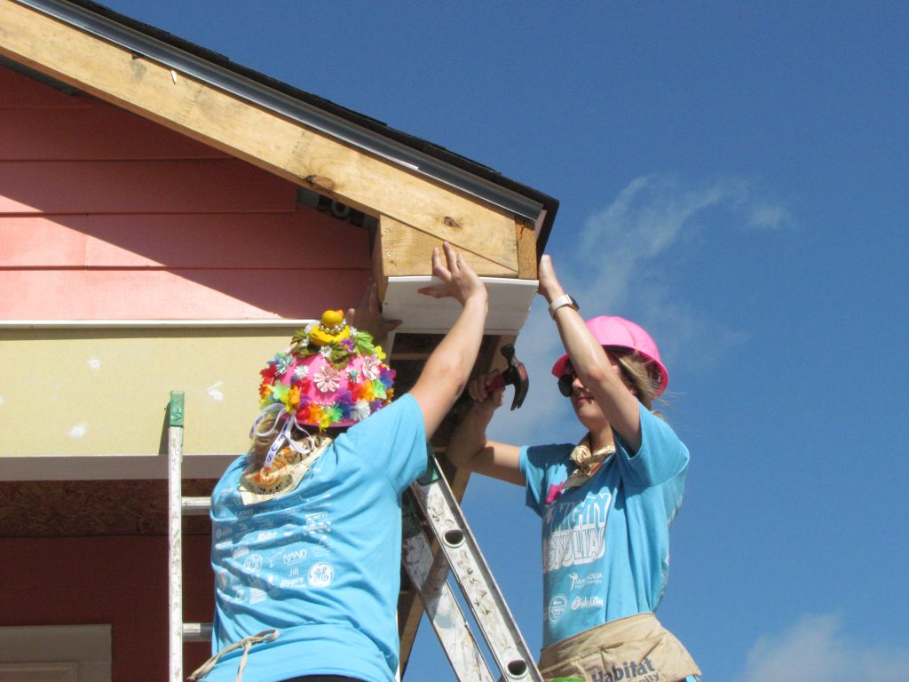 Volunteers working on soffit and fascia at Women Build 2019.