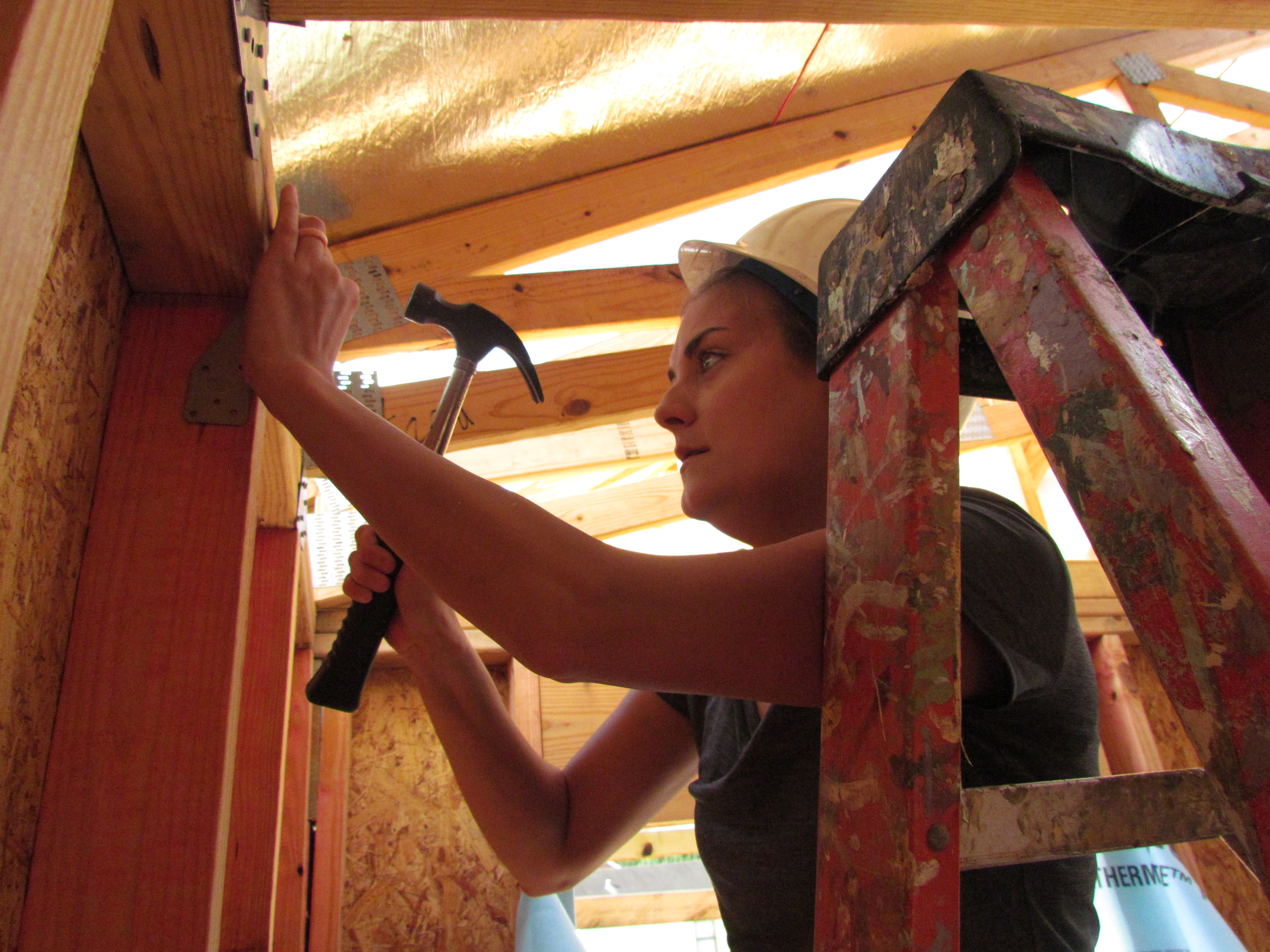 A Bench and Bar volunteer working on the interior of a Habitat home.